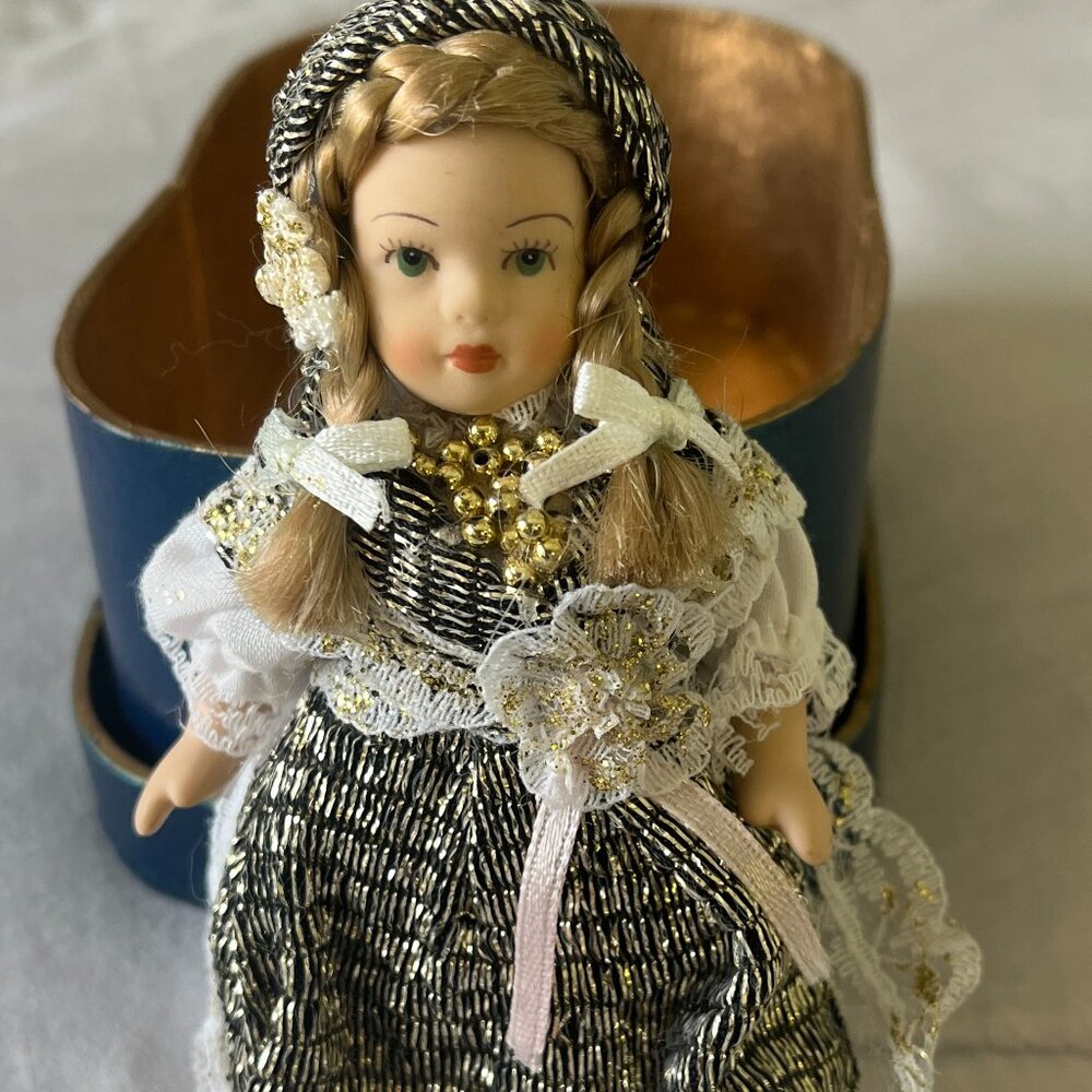 Small Porcelain Doll with Metallic Skirt & Scarf.  5 inches Tall